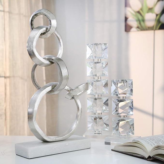 Linked Silver Rings On Marble Base